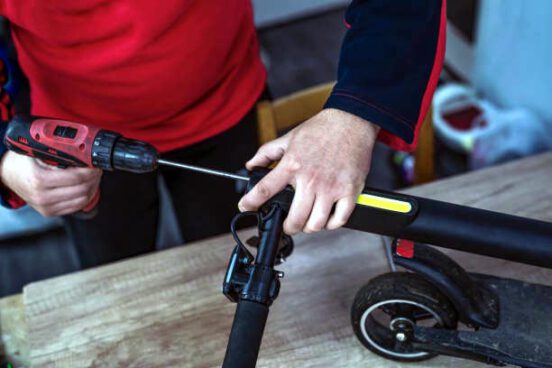 Repairing electrical scooter in special workshop.